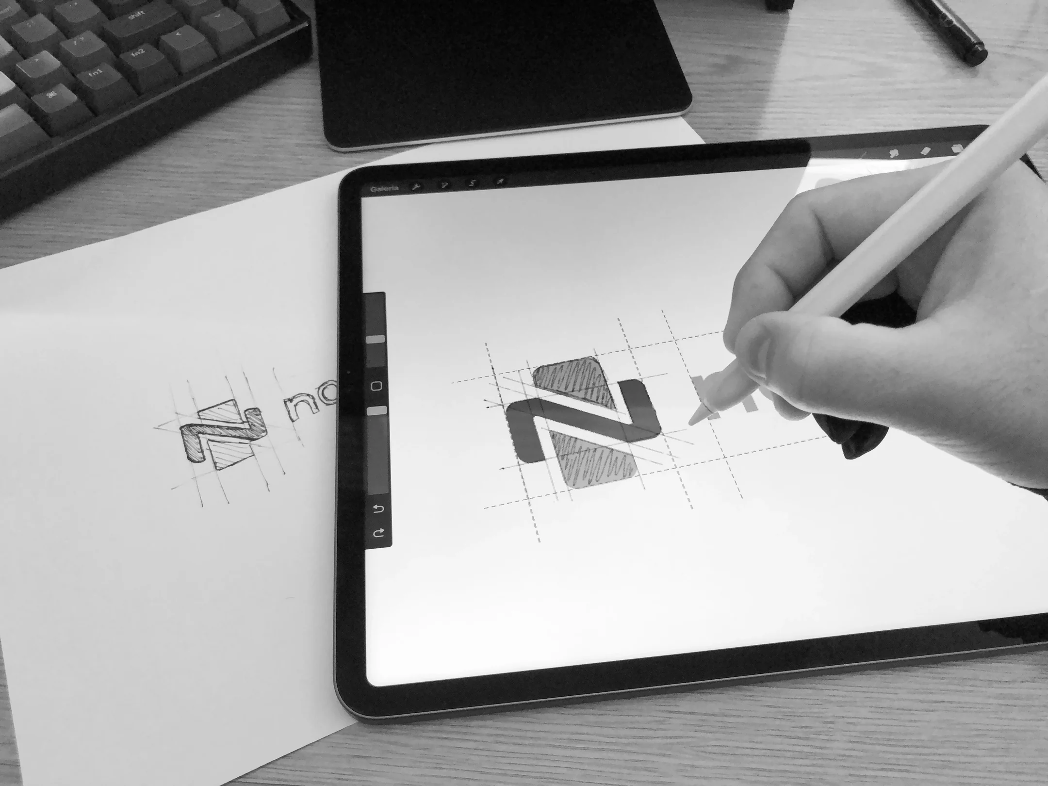 Sketching the NovacsHealth symbol on paper and refining it on an iPad over its construction grid